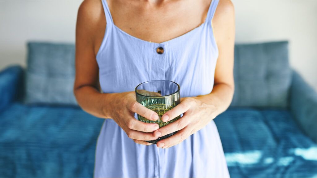 Une personne tenant un verre d’eau-1.